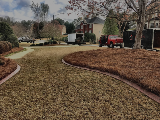 Dixon Landscape Services trucks and trailer at a North Georgia job site with a freshly maintained lawn